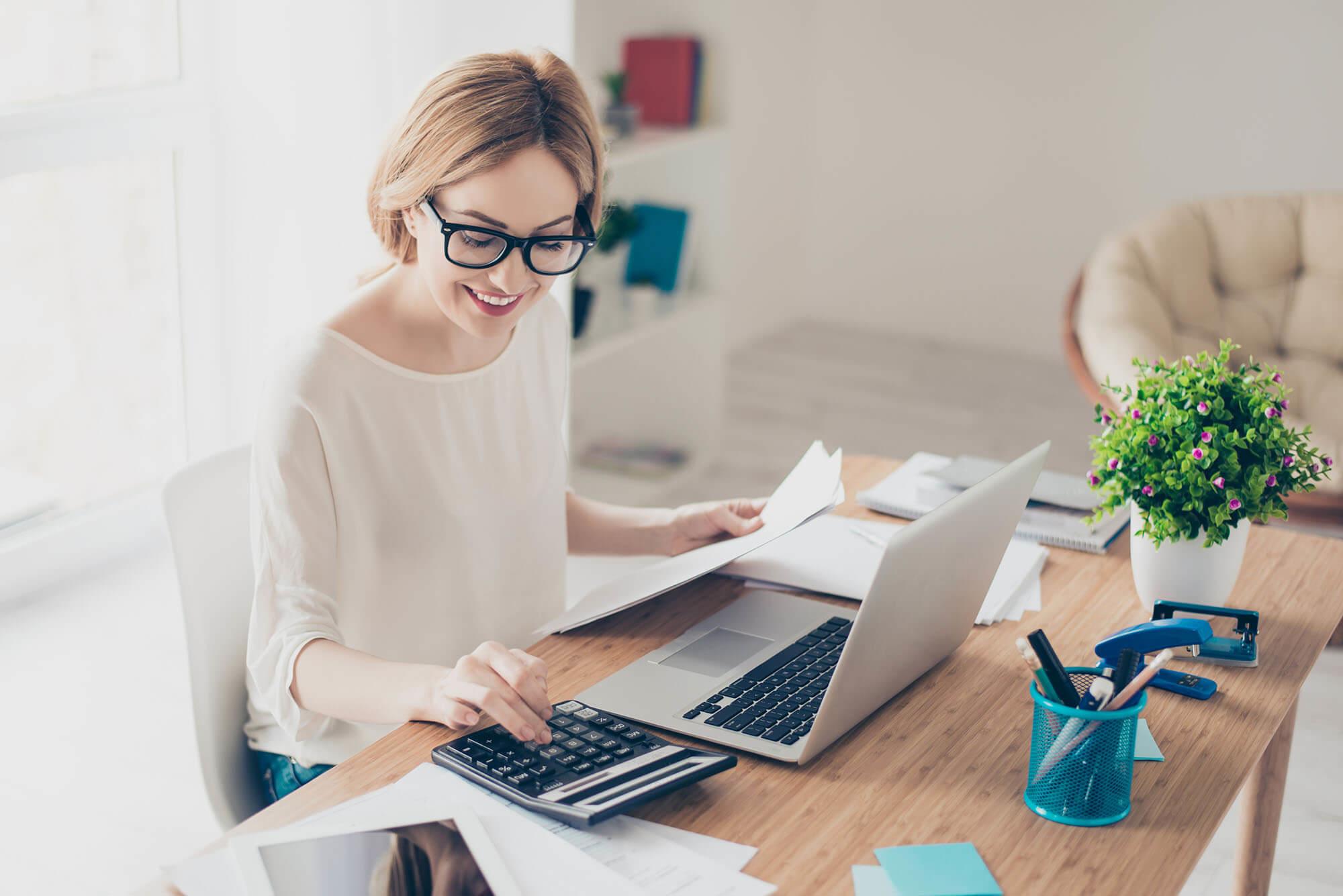 Bookkeeper with calculator and computer